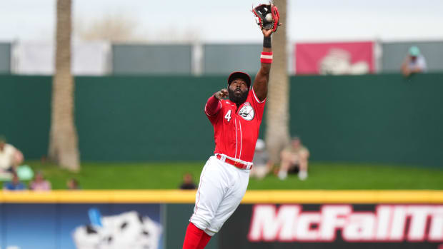 Cincinnati Reds second baseman Josh Harrison leaps to catch a line drive for an out in the first inning during a MLB spring training baseball game against the Seattle Mariners, Monday, Feb. 26, 2024, at Goodyear Ballpark in Goodyear, Ariz.