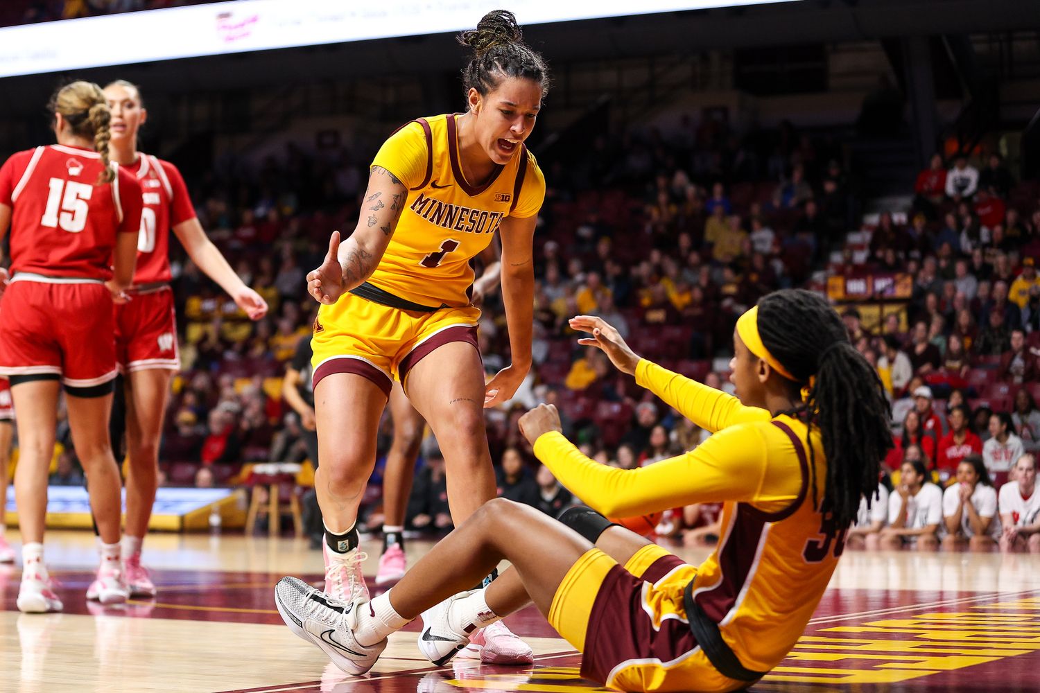 Minnesota forward Ayianna Johnson (1) reacts after guard Janay Sanders (30) draws a foul during the first half against Wisconsin at Williams Arena in Minneapolis on Feb. 20, 2024.