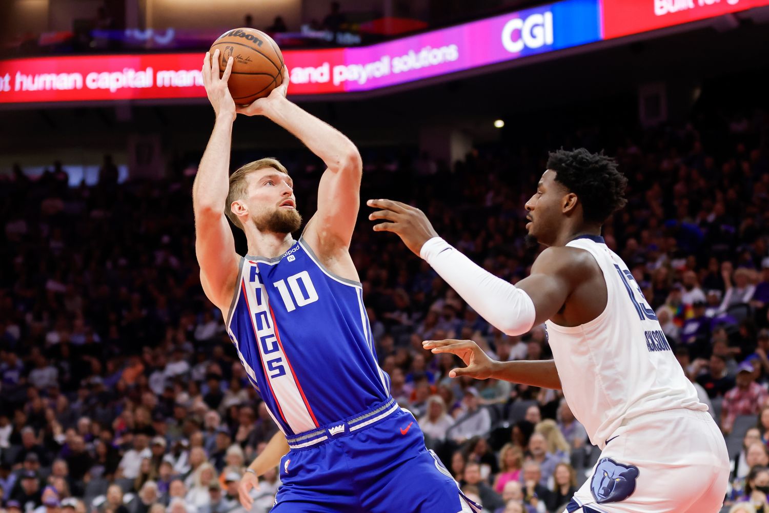 Mar 18, 2024; Sacramento, California, USA; Sacramento Kings forward Domantas Sabonis (10) shoots the ball against Memphis Grizzlies forward Jaren Jackson Jr. (13) during the first quarter at Golden 1 Center. Mandatory Credit: Sergio Estrada-USA TODAY Sports