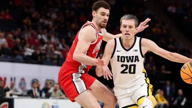 Mar 14, 2024; Minneapolis, MN, USA; Iowa Hawkeyes forward Payton Sandfort (20) dribbles around Ohio State Buckeyes forward Jamison Battle (10) during the first half at Target Center. Mandatory Credit: Matt Krohn-USA TODAY Sports