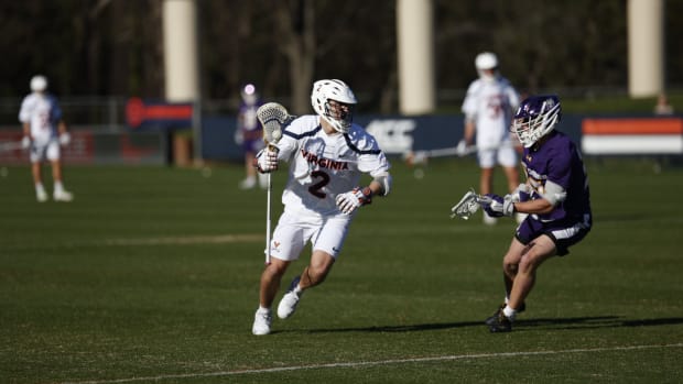 Thomas Mencke dodges with the ball during the Virginia men's lacrosse game against Albany at Klockner Stadium.