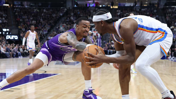 Feb 6, 2024; Salt Lake City, Utah, USA; Utah Jazz forward John Collins (20) and Oklahoma City Thunder guard Shai Gilgeous-Alexander (2) battle for the ball during the fourth quarter at Delta Center. Mandatory Credit: Rob Gray-USA TODAY Sports