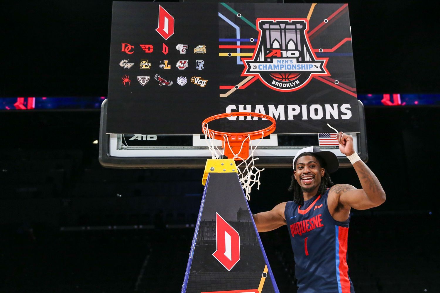 Mar 17, 2024; Brooklyn, NY, USA; Duquesne Dukes guard Jimmy Clark III (1) cuts the nets after winning the Atlantic 10 Tournament Championship at Barclays Center. Mandatory Credit: Wendell Cruz-USA TODAY Sports