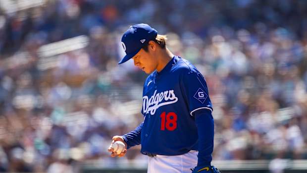 Mar 13, 2024; Phoenix, Arizona, USA; Los Angeles Dodgers pitcher Yoshinobu Yamamoto reacts against the Seattle Mariners during a spring training game at Camelback Ranch-Glendale.