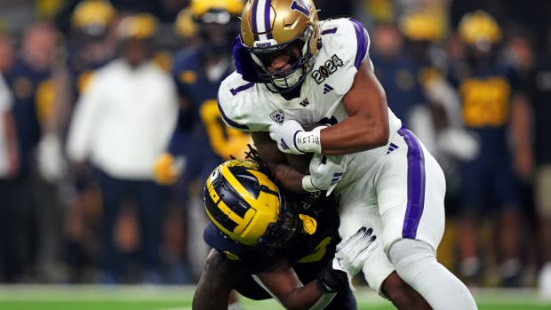 Rome Odunze tucks in the ball after a catch against Michigan in the national championship game.