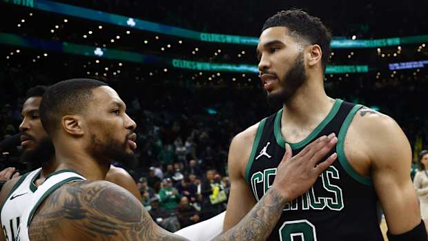 Boston Celtics forward Jayson Tatum (0) and Milwaukee Bucks guard Damian Lillard (0) 