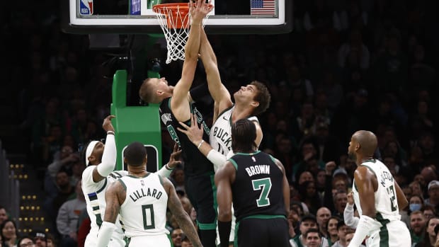 Boston Celtics center Kristaps Porzingis (8) and Milwaukee Bucks center Brook Lopez (11) 