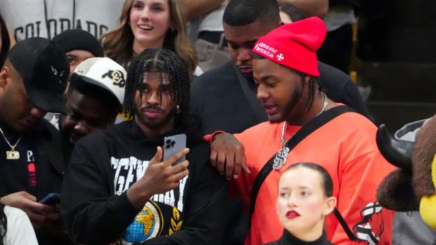 Colorado football stars Shedeur Sanders and Jordan Seaton attend a Buffaloes basketball game.