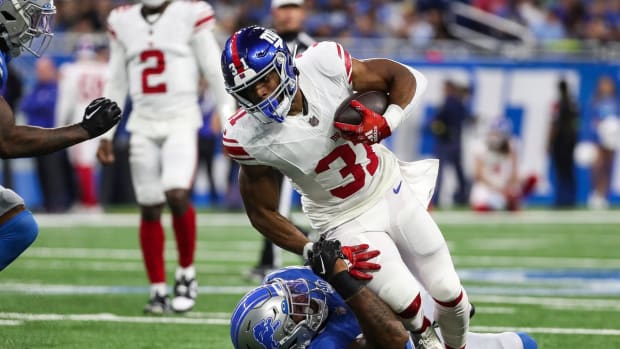 New York Giants running back Matt Breida (31) is stopped by Detroit Lions linebacker Derrick Barnes (55) during the first half of a preseason game at Ford Field in Detroit on Friday, Aug. 11, 2023.