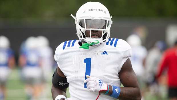 Kansas senior safety Kenny Logan Jr. (1) runs during Monday's outdoor practice.  