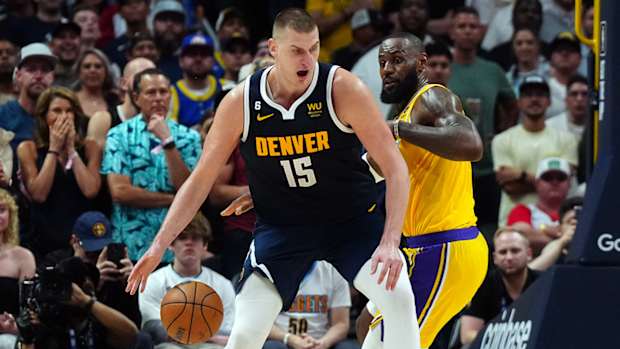 Nuggets’ Nikola Jokić posts up Lakers’ LeBron James.