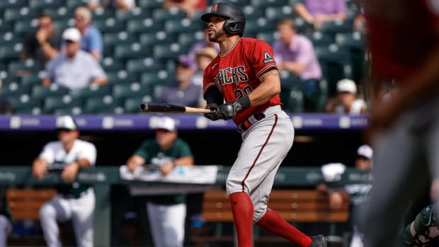 Diamondbacks outfielder Tommy Pham looks on after hitting a ball in a game vs. the Rockies.
