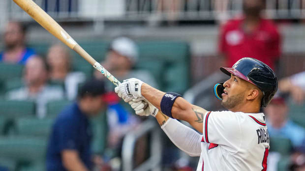 Aug 22, 2023; Cumberland, Georgia, USA; Atlanta Braves left fielder Eddie Rosario (8) watches the ball after hitting a two run home run against the New York Mets during the second inning at Truist Park.