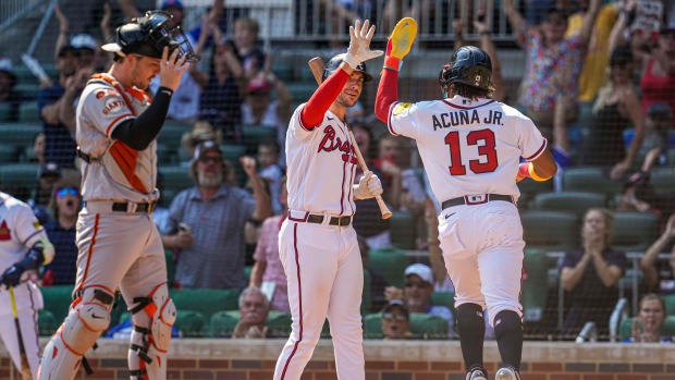 Aug 20, 2023; Cumberland, Georgia, USA; Atlanta Braves right fielder Ronald Acuna Jr. (13) reacts with first baseman Matt Olson (28) after scoring a run against the San Francisco Giants during the eighth inning at Truist Park.