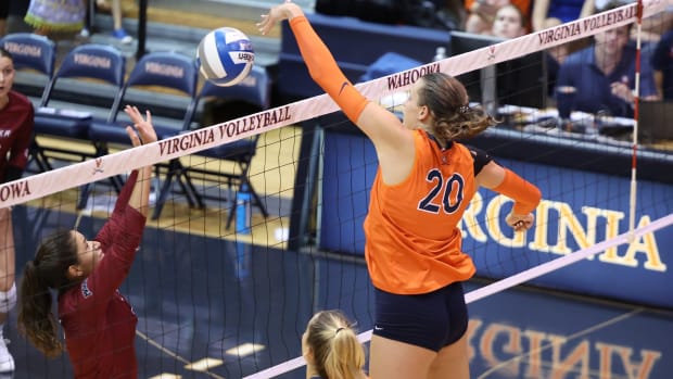 Chloe Wilson plays a ball over the net during the Virginia volleyball match against Rider at Memorial Gymnasium.
