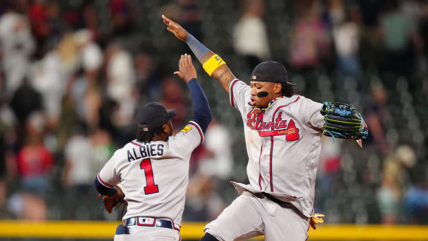 Aug 29, 2023; Denver, Colorado, USA; Atlanta Braves right fielder Ronald Acuna Jr. (13) and second baseman Ozzie Albies (1) celebrate defeating the Colorado Rockies at Coors Field.