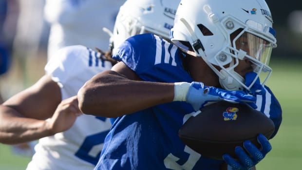 Kansas redshirt sophomore Tanaka Scott (3) runs after a catch during a drill at Wednesday's fall camp practice.  