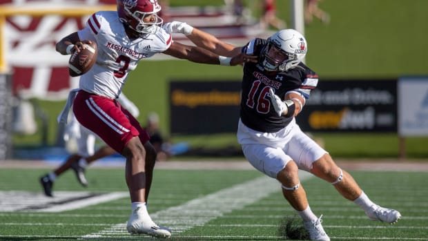 Aggie linebacker Gabe Peterson reaches for UMass quarterback Taisun Phommachanh during an Aggie football game on Saturday, August 256 2023, at the Aggie Memorial Stadium.  