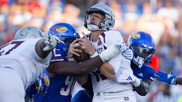 Kansas redshirt senior linebacker Tristian Fletcher (19) and junior defensive lineman Jereme Robinson (90) takes down Missouri State quarterback Jacob Clark (12) in the first quarter of Friday's game inside David Booth Kansas Memorial Stadium.  