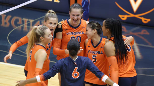 The Virginia volleyball team celebrates after a point during the match against Rider at Memorial Gymnasium.