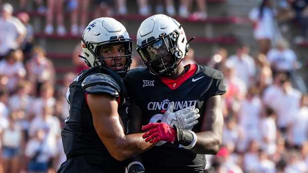 Cincinnati Bearcats linebacker Daniel Grzesiak (9) and defensive end Eric Phillips (97) share a moment during the second half of the NCAA football game between the Cincinnati Bearcats and the Eastern Kentucky Colonels at Nippert Stadium in Cincinnati on Saturday, Sept. 2, 2023. Cincinnati Bearcats won 66-13.  