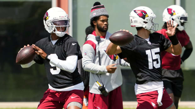 Cardinals quarterbacks Joshua Dobbs and Clayton Tune throw passes during a practice as Kyler Murray looks on.