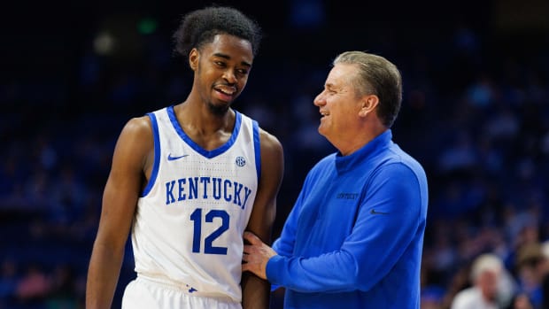 Nov 3, 2022; Lexington, Kentucky, USA; Kentucky Wildcats guard Antonio Reeves (12) talks with head coach John Calipari during the second half against the Kentucky State Thoroughbreds at Rupp Arena at Central Bank Center. Mandatory Credit: Jordan Prather-USA TODAY Sports