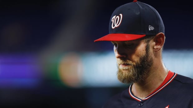 Nationals starting pitcher Stephen Strasburg looks down while walking off the mound in a game.