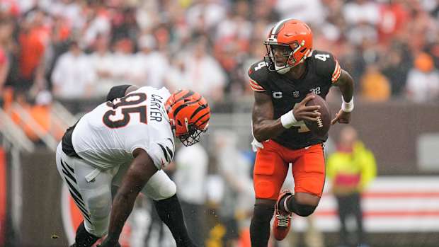Cincinnati Bengals defensive tackle Zach Carter (95) stumbles as he chases Cleveland Browns quarterback Deshaun Watson (4) out of the pocket in the first quarter of the NFL Week 1 game between the Cleveland Browns and the Cincinnati Bengals at FirstEnergy Stadium in downtown Cleveland on Sunday, Sept. 10, 2023. The Browns led 10-0 at halftime.