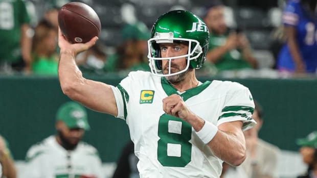 Jets quarterback Aaron Rodgers throws a pass in warmups before a game.
