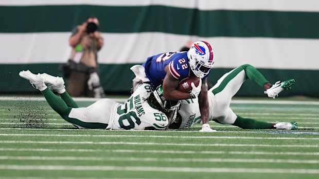 Jets' LB Quincy Williams tackles Bills' RB Damien Harris