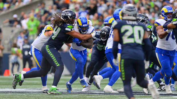 Sep 10, 2023; Seattle, Washington, USA; Los Angeles Rams running back Cam Akers (3) carries the ball while Seattle Seahawks defensive end Mike Morris (94) tries to tackle during the second half at Lumen Field. Mandatory Credit: Steven Bisig-USA TODAY Sports