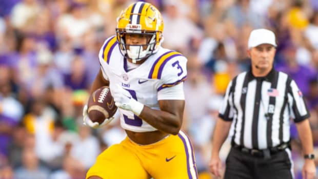 LSU Tigers running back Logan Diggs on a carry during a college football game in the SEC.