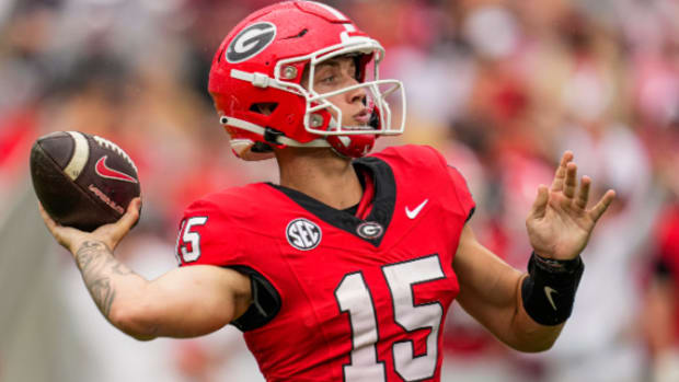 Georgia Bulldogs quarterback Carson Beck attempts a pass during a college football game in the SEC.