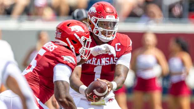 Razorbacks quarterback KJ Jefferson handing off to running back Raheim "Rocket" Sanders in opener