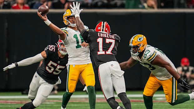 Sep 17, 2023; Atlanta, Georgia, USA; Green Bay Packers quarterback Jordan Love (10) passes under pressure from Atlanta Falcons linebacker Kaden Elliss (55) and linebacker Arnold Ebiketie (17) during the second half at Mercedes-Benz Stadium.
