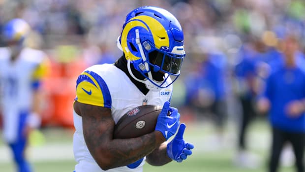 Rams running back Cam Akers carries a football.