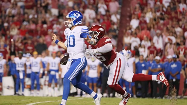 Sep 16, 2023; Fayetteville, Arkansas, USA; Arkansas Razorbacks defensive lineman John Morgan III (6) knocks the ball loose from BYU Cougars quarterback Kedon Slovis (10) during the second quarter at Donald W. Reynolds Razorback Stadium. Mandatory Credit: Nelson Chenault-USA TODAY Sports  