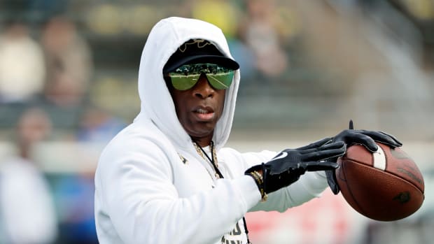 Colorado Buffaloes head coach Deion Sanders throws during warm ups before the game against the Oregon Ducks at Autzen Stadium