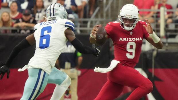 Sep 24, 2023; Glendale, Arizona, United States; Arizona Cardinals quarterback Joshua Dobbs (9) scrambles past Dallas Cowboys safety Donovan Wilson (6) at State Farm Stadium.