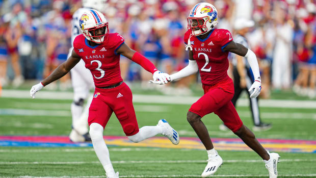 Sep 23, 2023; Lawrence, Kansas, USA; Kansas Jayhawks cornerback Cobee Bryant (2) celebrates with cornerback Mello Dotson (3) after an interception against the Brigham Young Cougars during the second half at David Booth Kansas Memorial Stadium. Mandatory Credit: Jay Biggerstaff-USA TODAY Sports  