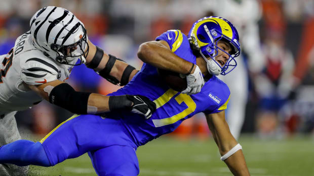 Sep 25, 2023; Cincinnati, Ohio, USA; Los Angeles Rams wide receiver Puka Nacua (17) advances the ball against Cincinnati Bengals defensive end Sam Hubbard (94) in the first half at Paycor Stadium.