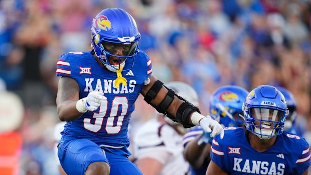 Sep 1, 2023; Lawrence, Kansas, USA; Kansas Jayhawks linebacker Rich Miller (30) and defensive lineman Austin Booker (9) celebrate after a play during the first half against the Missouri State Bearsa at David Booth Kansas Memorial Stadium. Mandatory Credit: Jay Biggerstaff-USA TODAY Sports  
