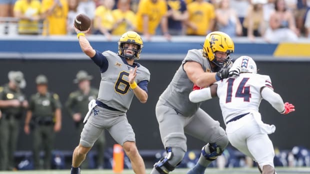 West Virginia Mountaineers quarterback Garrett Greene (6) throws a pass during the first quarter against the Duquesne Dukes at Mountaineer Field at Milan Puskar Stadium.