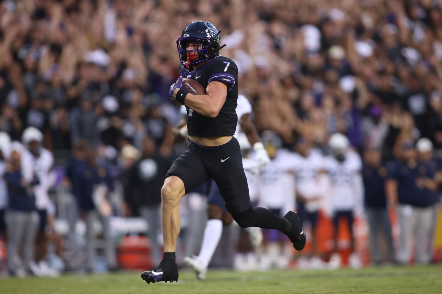 TCU Horned Frogs wide receiver JP Richardson (7) runs for a touchdown after catching a pass against West Virginia Mountaineers safety Anthony Wilson (12) in the first quarter at Amon G. Carter Stadium.
