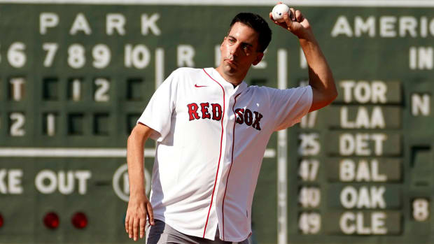 Chris Snow, an assistant general manager for the Calgary Flames, throws out a ceremonial first pitch before a Boston Red Sox baseball game in 2021.
