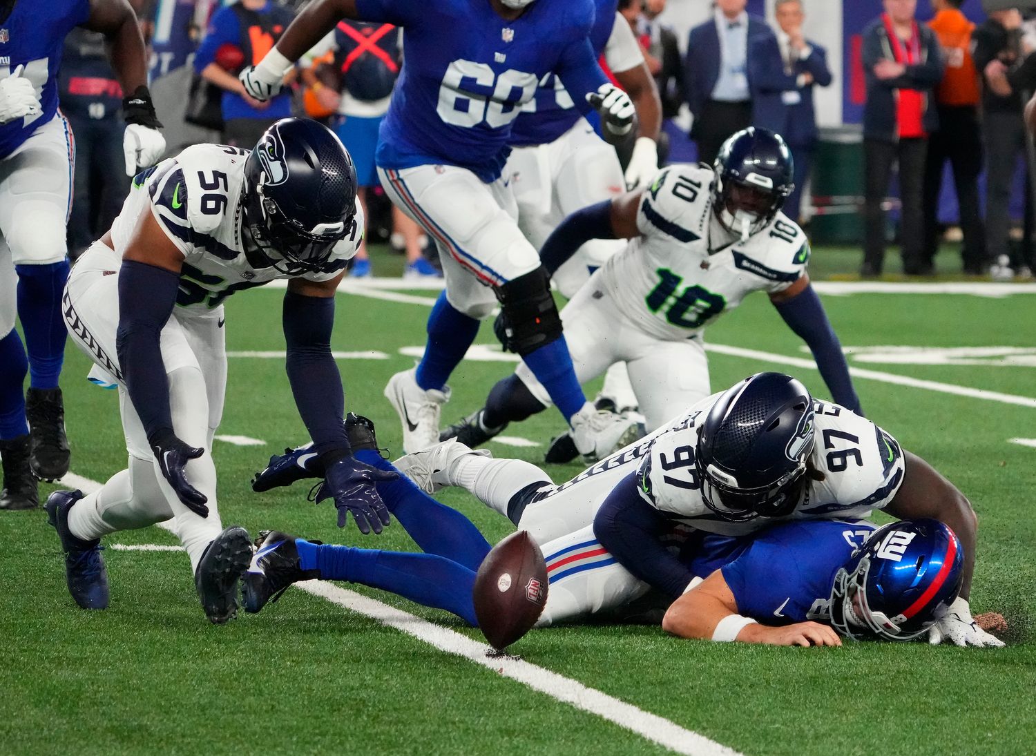Oct 2, 2023; East Rutherford, New Jersey, USA; Seattle Seahawks linebacker Jordyn Brooks (56) picks up the loose ball after defensive end Mario Edwards Jr. (97) stripped the ball from New York Giants quarterback Daniel Jones (8) at MetLife Stadium. Mandatory Credit: Robert Deutsch-USA TODAY Sports