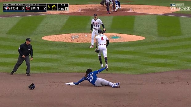 Twins starter Sonny Gray and shortstop Carlos Correa celebrate after picking off Blue Jays first baseman Vladimir Guerrero Jr. in a playoff game.