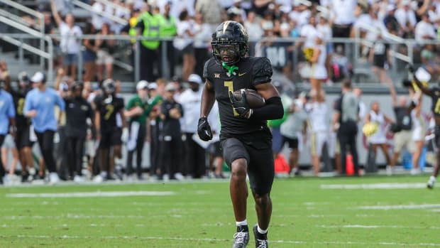 Sep 30, 2023; Orlando, Florida, USA; UCF Knights wide receiver Javon Baker (1) runs the ball for a touchdown during the first quarter against the Baylor Bears at FBC Mortgage Stadium.