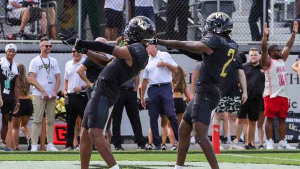 Sep 30, 2023; Orlando, Florida, USA; UCF Knights wide receiver Javon Baker (L) celebrates his touchdown during the first quarter against the Baylor Bears at FBC Mortgage Stadium. Mandatory Credit: Mike Watters-USA TODAY Sports  